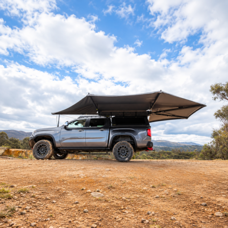 Overland Truck Beneath Expansive Skies Ironman 4x4 Deltawing 270 XL Left Hand Freestanding Awning Grey Blackout Canvas Integrated LED Lighting